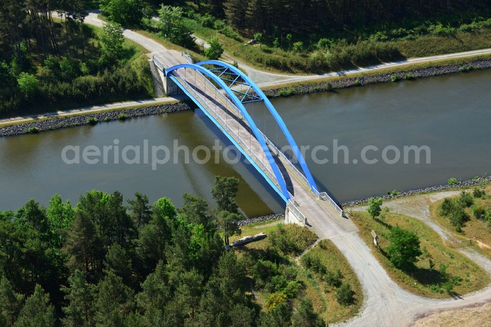 Burg (bei Magdeburg) from the bird's eye view: Bridge over the Elbe-Havel-Kanal in the West of the town of Burg (bei Magdeburg) in the state of Saxony-Anhalt. The distinct blue arc bridge spans the canal in the West of the town. The bridge is surrounded by forest and is one of several bridges on the canal