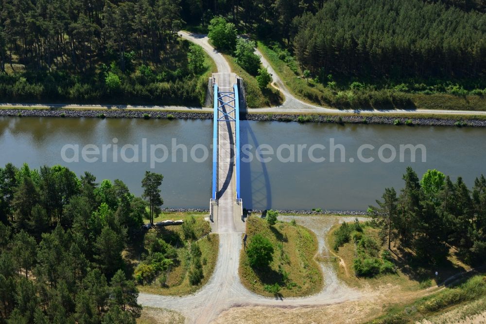 Aerial image Burg (bei Magdeburg) - Bridge over the Elbe-Havel-Kanal in the West of the town of Burg (bei Magdeburg) in the state of Saxony-Anhalt. The distinct blue arc bridge spans the canal in the West of the town. The bridge is surrounded by forest and is one of several bridges on the canal