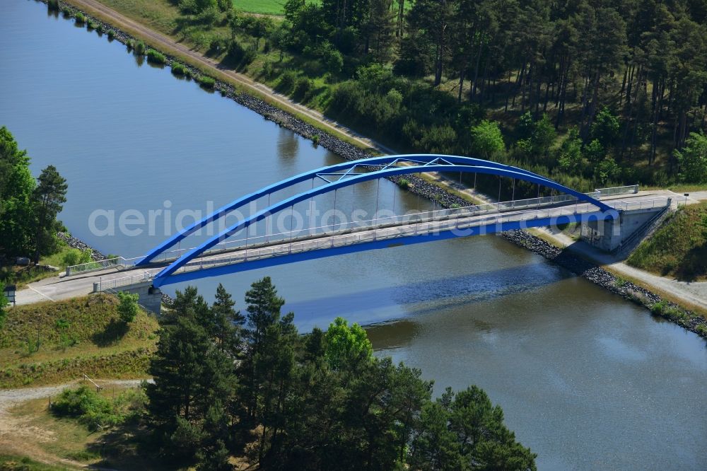 Burg (bei Magdeburg) from above - Bridge over the Elbe-Havel-Kanal in the West of the town of Burg (bei Magdeburg) in the state of Saxony-Anhalt. The distinct blue arc bridge spans the canal in the West of the town. The bridge is surrounded by forest and is one of several bridges on the canal