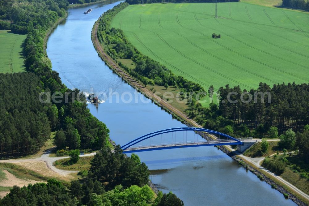 Burg (bei Magdeburg) from the bird's eye view: Bridge over the Elbe-Havel-Kanal in the West of the town of Burg (bei Magdeburg) in the state of Saxony-Anhalt. The distinct blue arc bridge spans the canal in the West of the town. The bridge is surrounded by forest and is one of several bridges on the canal