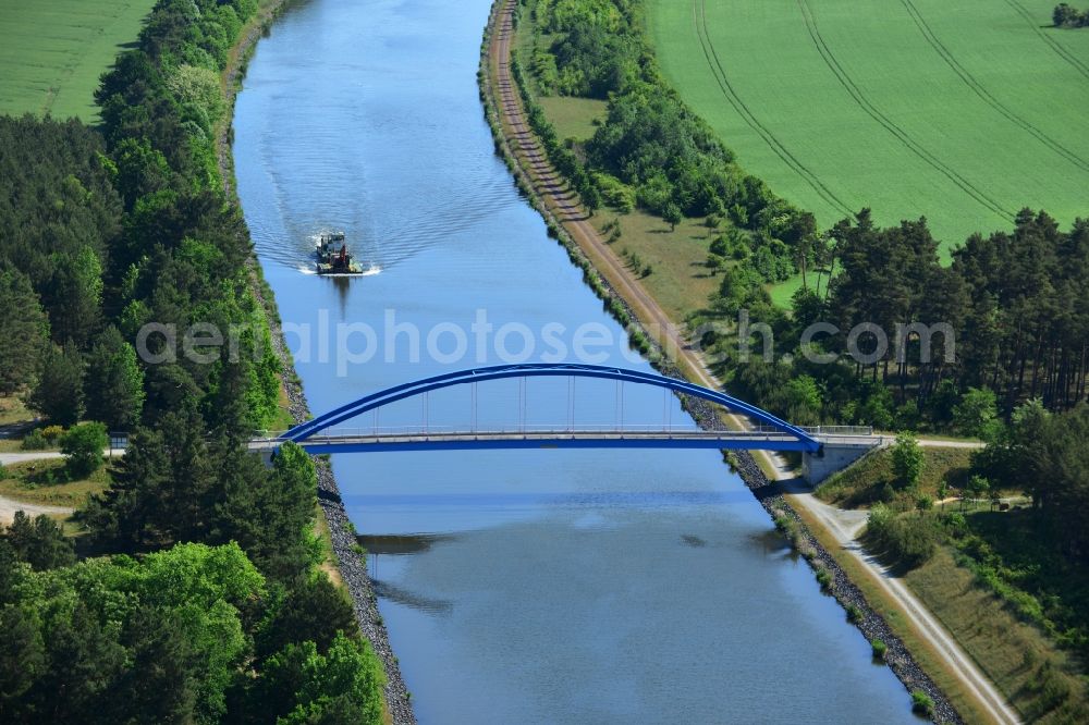 Aerial image Burg (bei Magdeburg) - Bridge over the Elbe-Havel-Kanal in the West of the town of Burg (bei Magdeburg) in the state of Saxony-Anhalt. The distinct blue arc bridge spans the canal in the West of the town. The bridge is surrounded by forest and is one of several bridges on the canal