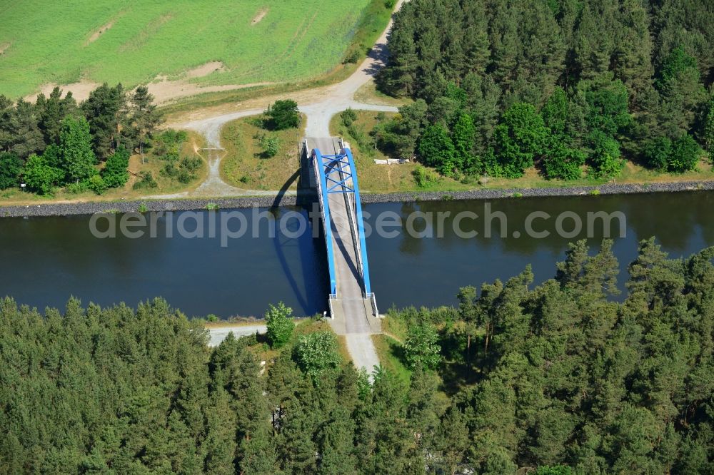 Burg (bei Magdeburg) from the bird's eye view: Bridge over the Elbe-Havel-Kanal in the West of the town of Burg (bei Magdeburg) in the state of Saxony-Anhalt. The distinct blue arc bridge spans the canal in the West of the town. The bridge is surrounded by forest and is one of several bridges on the canal