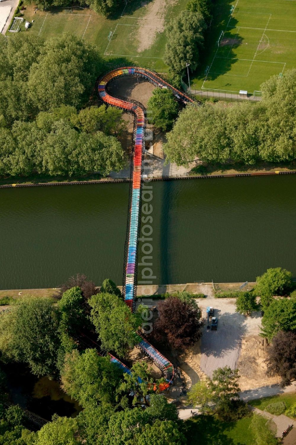 Oberhausen from above - View of the bridge Slinky Springs to Fame in Oberhausen in North Rhine-Westphalia. The bridge sculpture with spiral over the Rhine-Herne-Kanal was conceived within the framework of the art project Emscherkunst.2010 by the sculptor Tobias Rehberger in collaboration with the engineering firm Schlaich, Bergemann and Partner and opened in 2011. The pedestrian and bicycle bridge connects the garden of the castle with the Emscherinsel