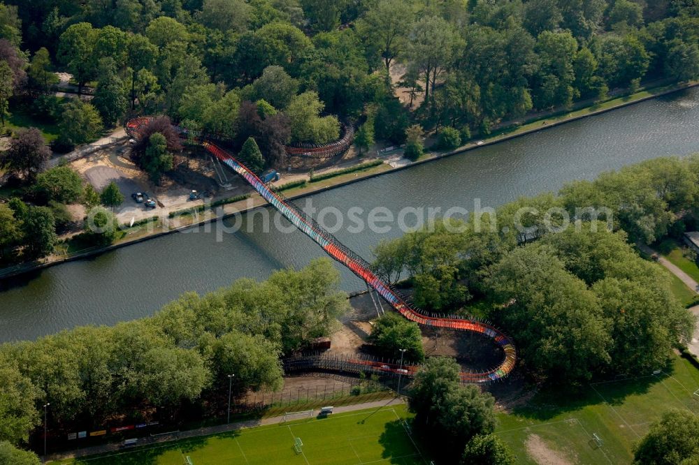 Aerial image Oberhausen - View of the bridge Slinky Springs to Fame in Oberhausen in North Rhine-Westphalia. The bridge sculpture with spiral over the Rhine-Herne-Kanal was conceived within the framework of the art project Emscherkunst.2010 by the sculptor Tobias Rehberger in collaboration with the engineering firm Schlaich, Bergemann and Partner and opened in 2011. The pedestrian and bicycle bridge connects the garden of the castle with the Emscherinsel