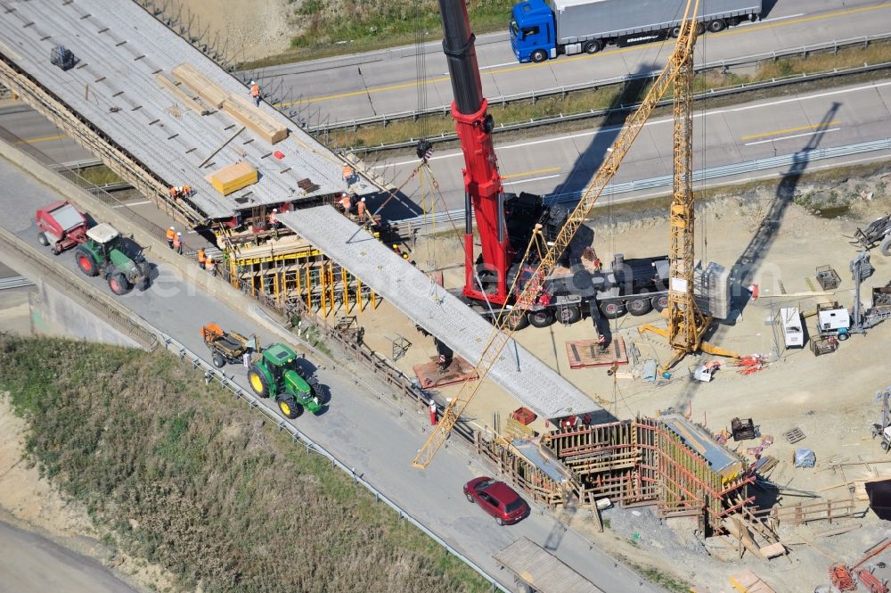 Dittersdorf from the bird's eye view: Buildings and route of the motorway A9 motorway with four lanes now. Currently, reconstruction, expansion and new construction work is underway for the six-lane expansion of Highway 9 between Triptis and Schleiz by Wayss & Freytag Ingenieurbau and EUROVIA VINCI