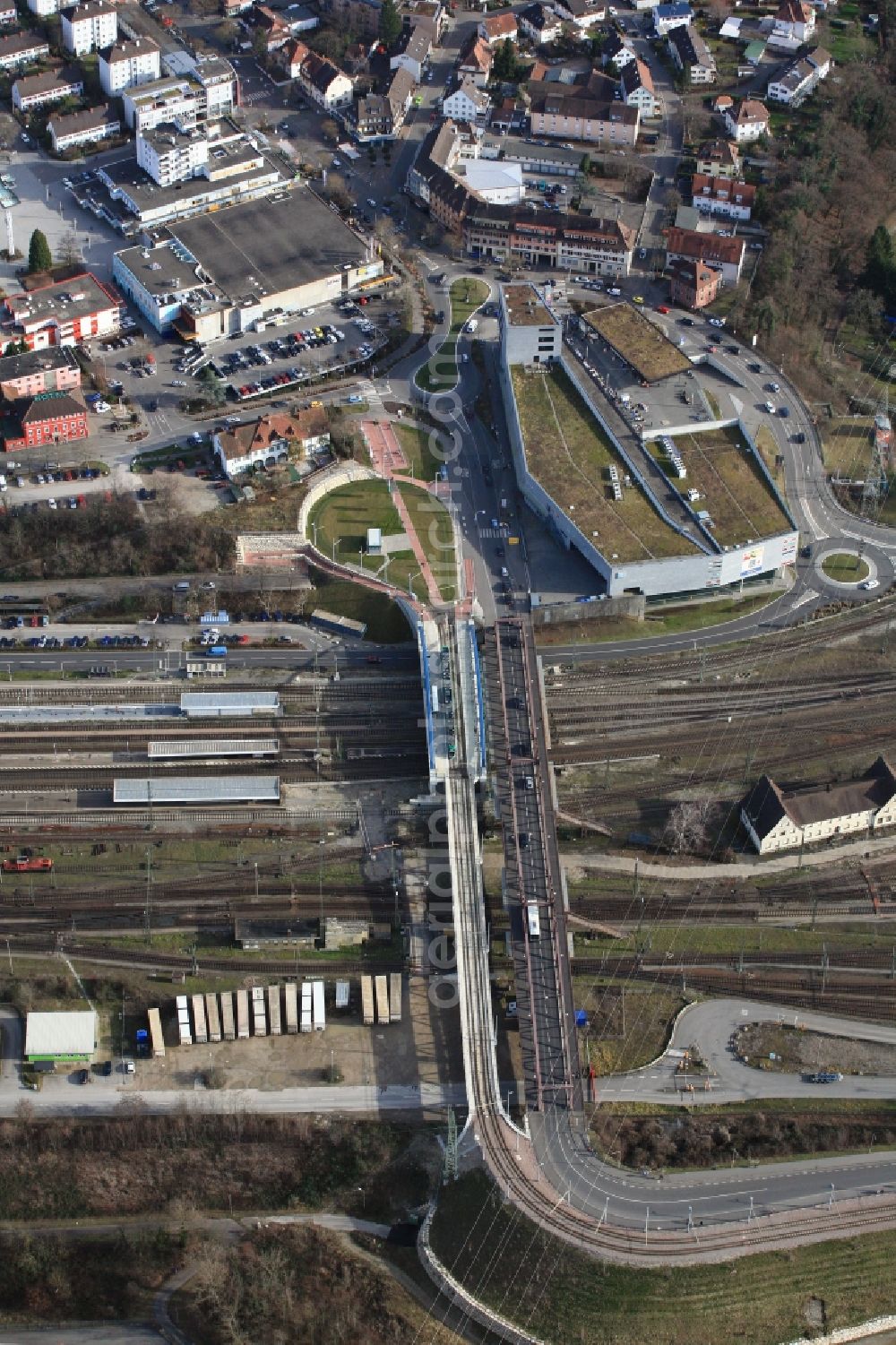 Aerial photograph Weil am Rhein - Road bridge Friedensbruecke over the railway tracks at the Station in Weil am Rhein in Baden-Wuerttemberg. Over the bridge runs the tram which connects cross-border the Swiss city Basel with Weil am Rhein