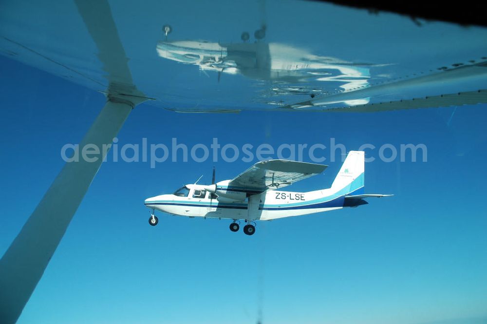 Aerial photograph Mosambik / Mozambique - Eine als Buschflieger genutzte Britten-Norman BN-2 Islan der über dem Küstenbereich vor Mosambik Lumbo. A bush plane used as a Britten-Norman BN-2 Islan der on the coastal area in front Lumbo Mozambique.