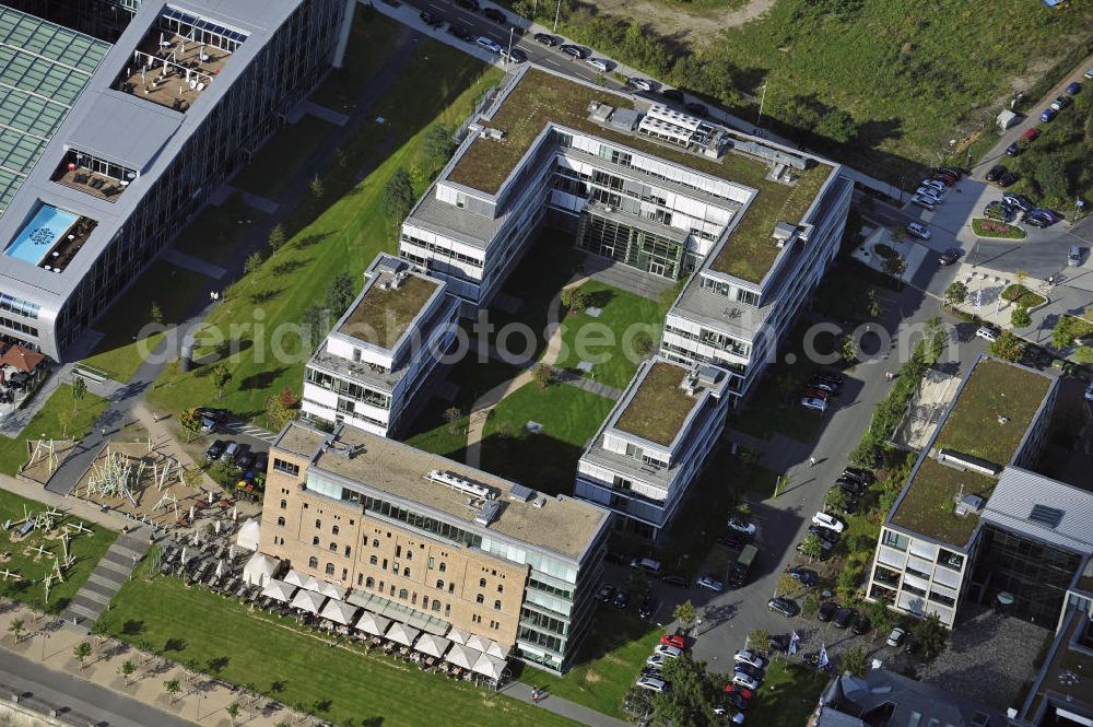 Aerial photograph Bonn - Der Büro-Campus Rheinwerk I mit der Rohmühle der ehemaligen Zementfabrik im Bonner Bogen im Stadtteil Ramersdorf. Im Bonner Bogen am Ufer des Rheins wurden Gebäude mit Büro- und Tourismusflächen errichtet. Bauherr war die BonnVisio Real Estate GmbH & Co. KG. The office campus Rheinwerk I with the raw mill of the former cement factory on the Bonn Arc in the district Ramersdorf.