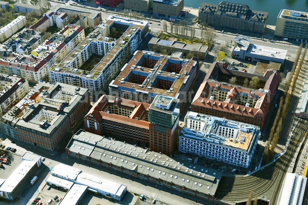 Berlin from the bird's eye view: Construction site on building of the monument protected former Osram respectively Narva company premises Oberbaum City in the district Friedrichshain in Berlin. Here, among many other companies, BASF Services Europe, the German Post Customer Service Center GmbH and Heineken Germany GmbH are located. It is owned by HVB Immobilien AG, which is part of the UniCredit Group