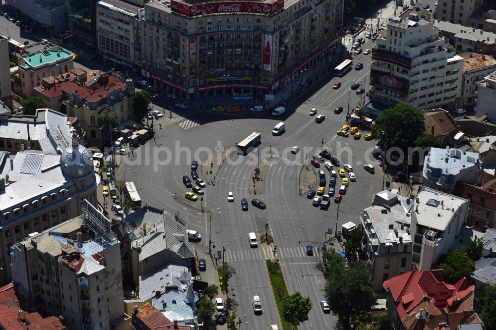 Aerial photograph Bukarest - Office building on the square Piata Romana in Sector 1 in the city center of Bucharest in Romania. The building is characterised by the distinct Coca-Cola advertisement on its roof. The square is one of the major traffic intersections of the city