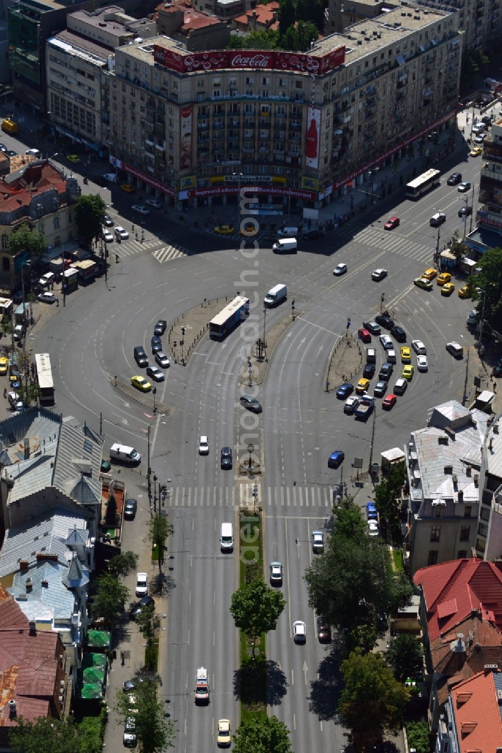 Bukarest from above - Office building on the square Piata Romana in Sector 1 in the city center of Bucharest in Romania. The building is characterised by the distinct Coca-Cola advertisement on its roof. The square is one of the major traffic intersections of the city