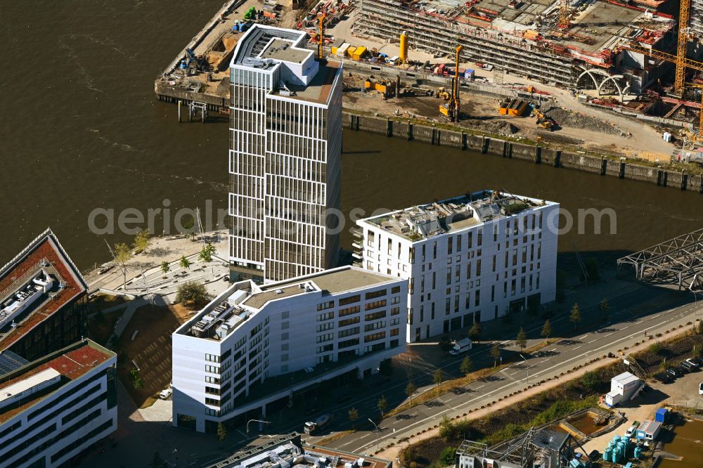 Hamburg from the bird's eye view: Administrative and commercial buildings on Ueberseeallee in the district HafenCity in Hamburg, Germany