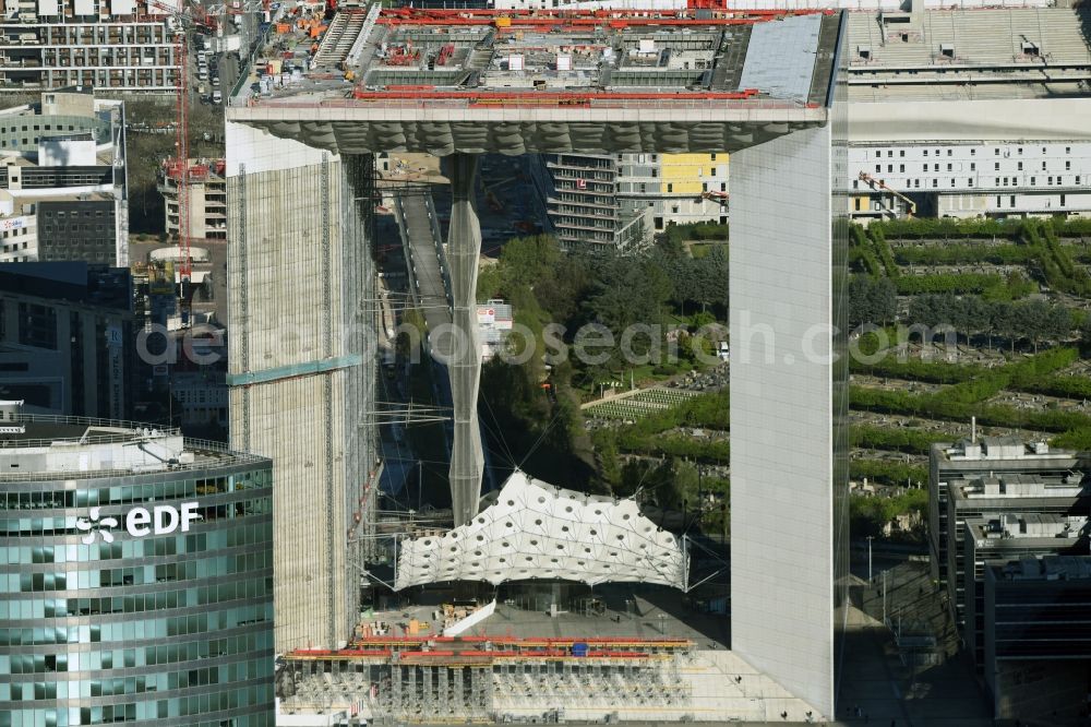 Aerial image Paris - Office building Grande Arche in the business quarter of highrise buildings La Défense in Paris in Ile-de-France, France. It is home to the ministry of commerce and traffic, to offices and the human rights association