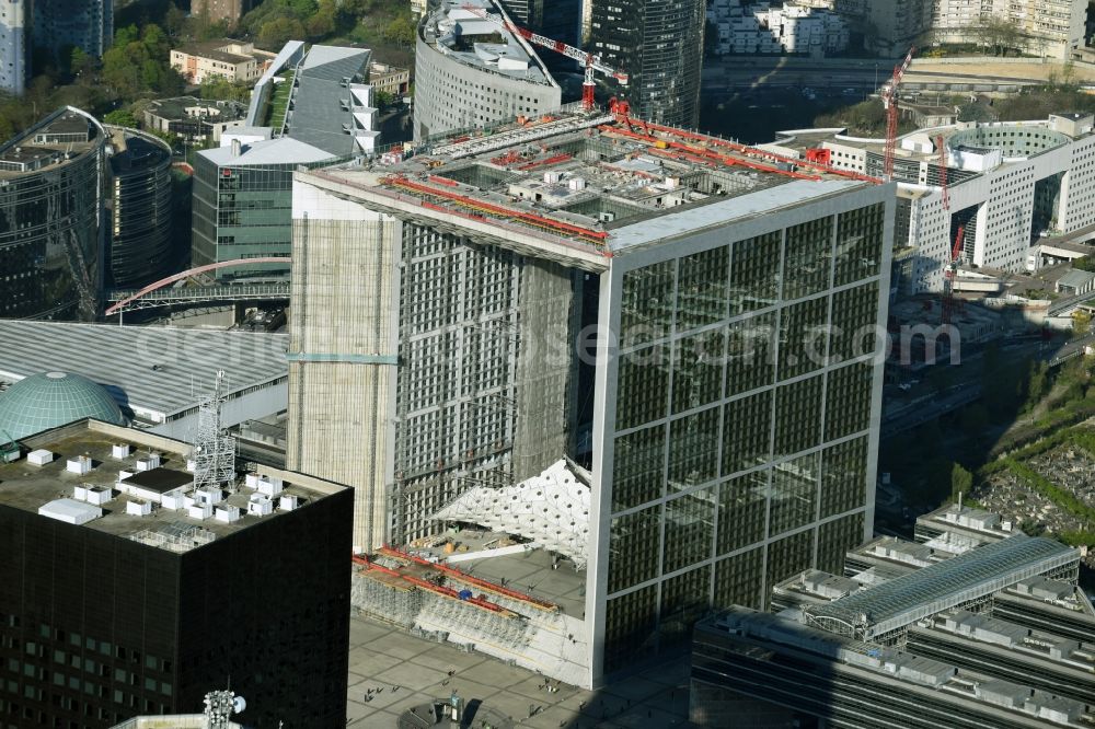 Aerial image Paris - Office building Grande Arche in the business quarter of highrise buildings La Défense in Paris in Ile-de-France, France. It is home to the ministry of commerce and traffic, to offices and the human rights association