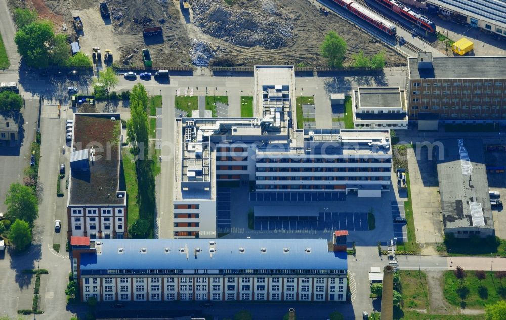 Berlin from the bird's eye view: Office building of the Deutsche Funkturm GmbH in the Lichtenberg district Berlin in Germany. The modern building is located on Buchberger Strasse, close to railway tracks and a construction site. DFMG is a sub-company of German Telekom and develops antennas