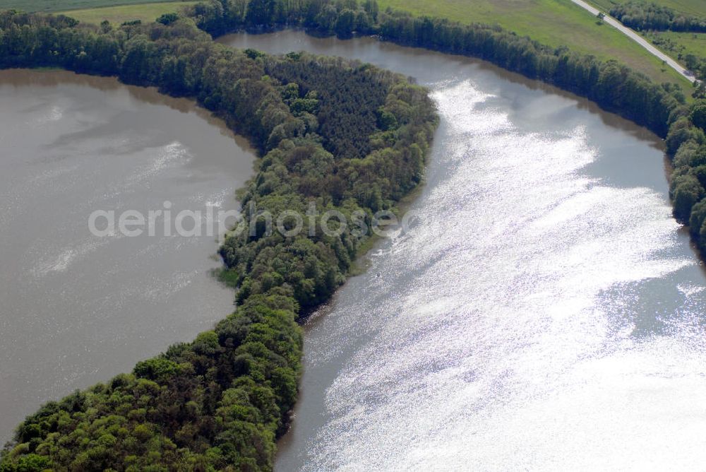 Bützow from the bird's eye view: Blick auf das Bützower Seeufer. Der Bützower See in Mecklenburg-Vorpommern liegt im Landkreis Güstrow in Westmecklenburg nordöstlich von Bützow. Er hat eine ungefähre Länge von rund 1,6 km, eine Breite von 1,1 km und eine durchschnittliche Tiefe von 1,10 m. Durch die geringe Tiefe ist der Südteil des Sees sehr verwachsen und verschmutzt. Am See befindet sich ein Wasserwan derrastplatz. Der See ist von landwirtschaftlicher Nutzfläche im Norden und Westen und der Bebauungsfläche von Bützow (Ost- und Südseite) umgeben.