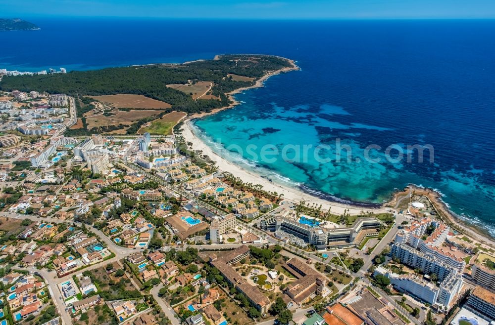 Sa Coma from the bird's eye view: Water surface at the bay along the sea coast beim Platja de sa Coma on Avinguda de les Savines in Sa Coma in Balearic island of Mallorca, Spain