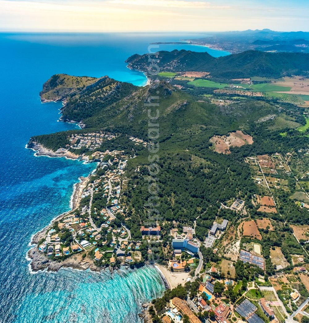 Aerial image Provensals - Water surface at the bay along the sea coast at the beach in the bay N'Aladern at Font de Sa Cala in Provensals in Balearic island of Mallorca, Spain