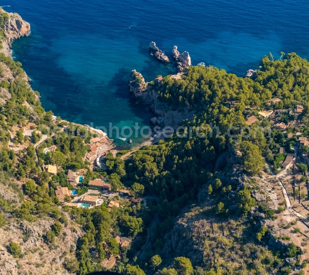 Aerial image Deia - Water surface at the bay along the sea coast Cale de Deya in Deia in Balearic island of Mallorca, Spain