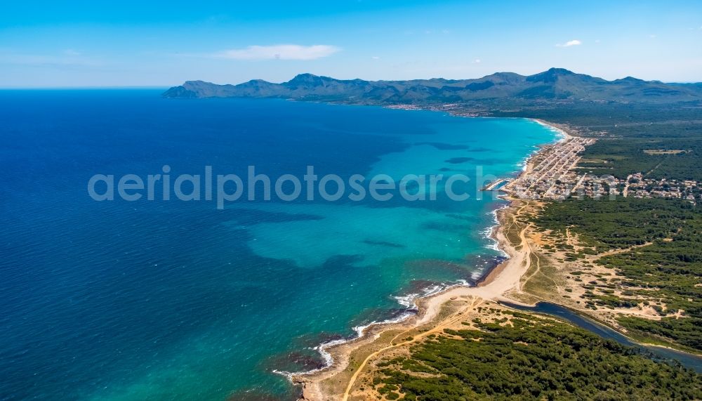 Son Serra de Marina from the bird's eye view: Water surface at the bay along the sea coast on Platja de Son Real in Son Serra de Marina in Balearic island of Mallorca, Spain