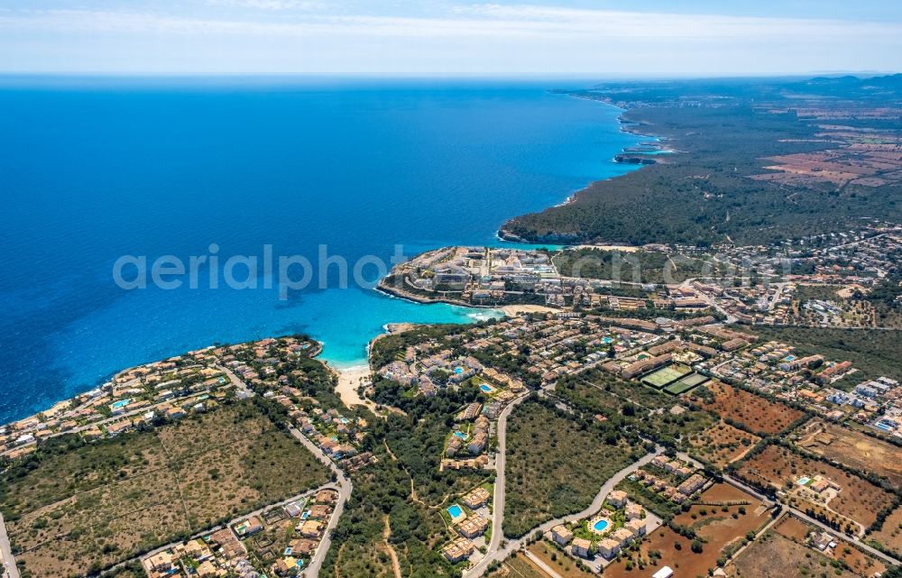 Aerial image Cala Mendia - Water surface at the bay along the sea coast with the beaches Platja de Cala Anguila and Playa de Cala Mandia in Cala Mendia in Balearic island of Mallorca, Spain