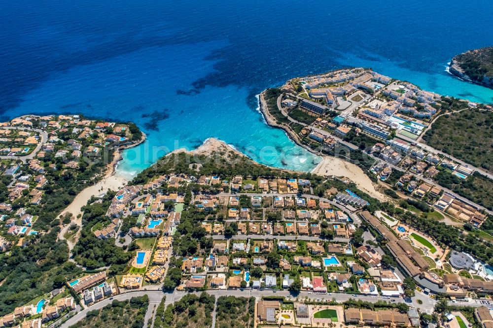 Cala Mendia from above - Water surface at the bay along the sea coast with the beaches Platja de Cala Anguila and Playa de Cala Mandia in Cala Mendia in Balearic island of Mallorca, Spain