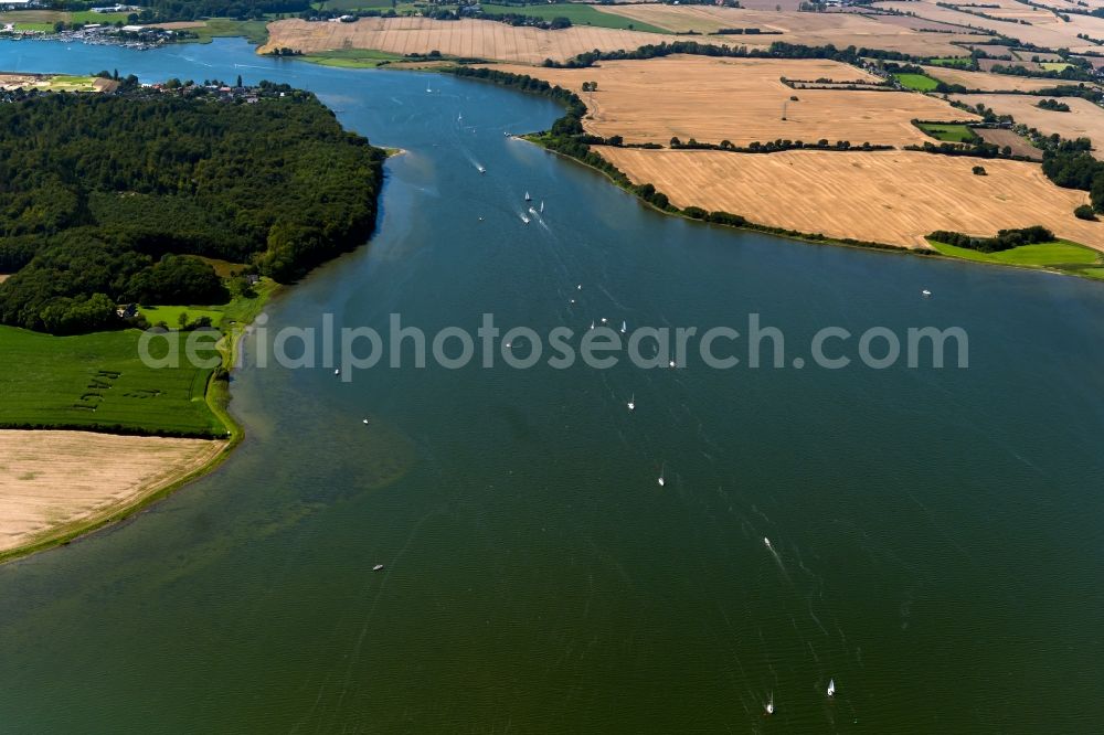 Aerial image Maasholm - Water surface with sailing ships in motion at the Schlei bay along the sea coast of the baltic sea in Maasholm in the state Schleswig-Holstein, Germany