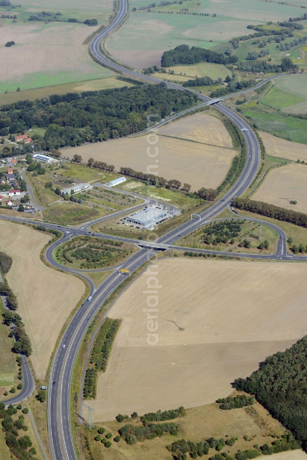 Blankenfelde-Mahlow from above - Federal highway and interchange at Dahlewitz in Blankenfelde-Mahlow in the state Brandenburg. The exit of the highway B96 is located amidst meadows and fields. A car dealer and workshop is located next to it