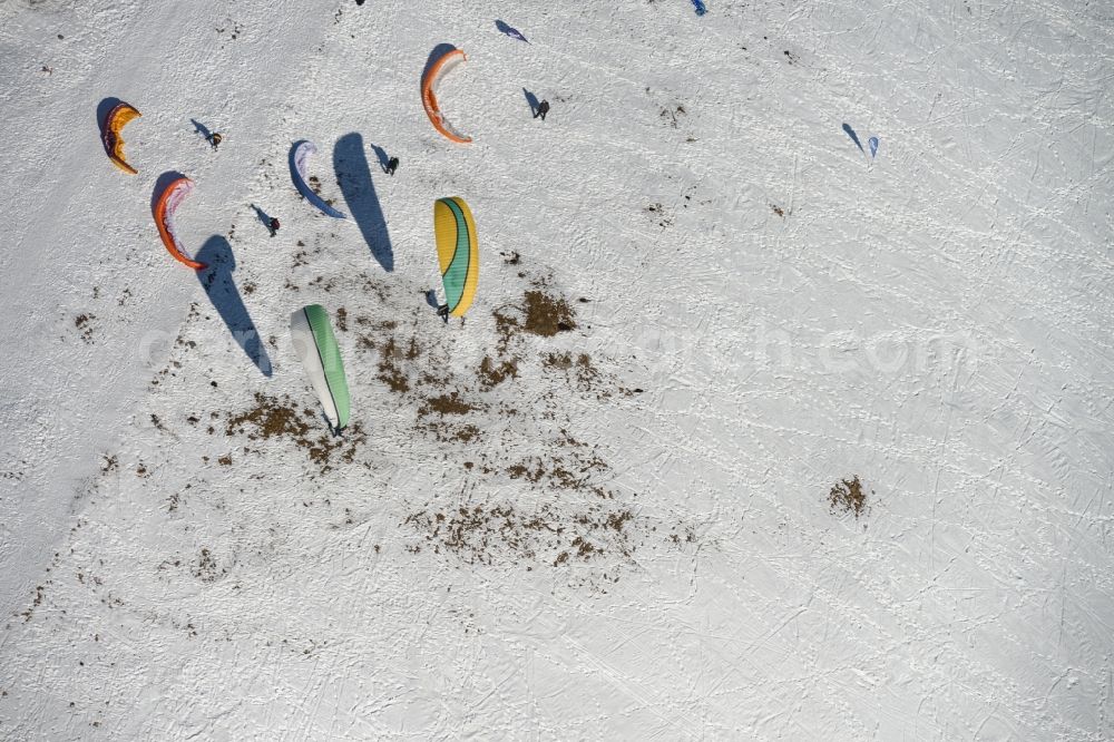 Aerial photograph Schmiedefeld am Rennsteig - Colorful Paraglider- flyer on a winter with Snowy hillside in Schmiedefeld in Thuringia