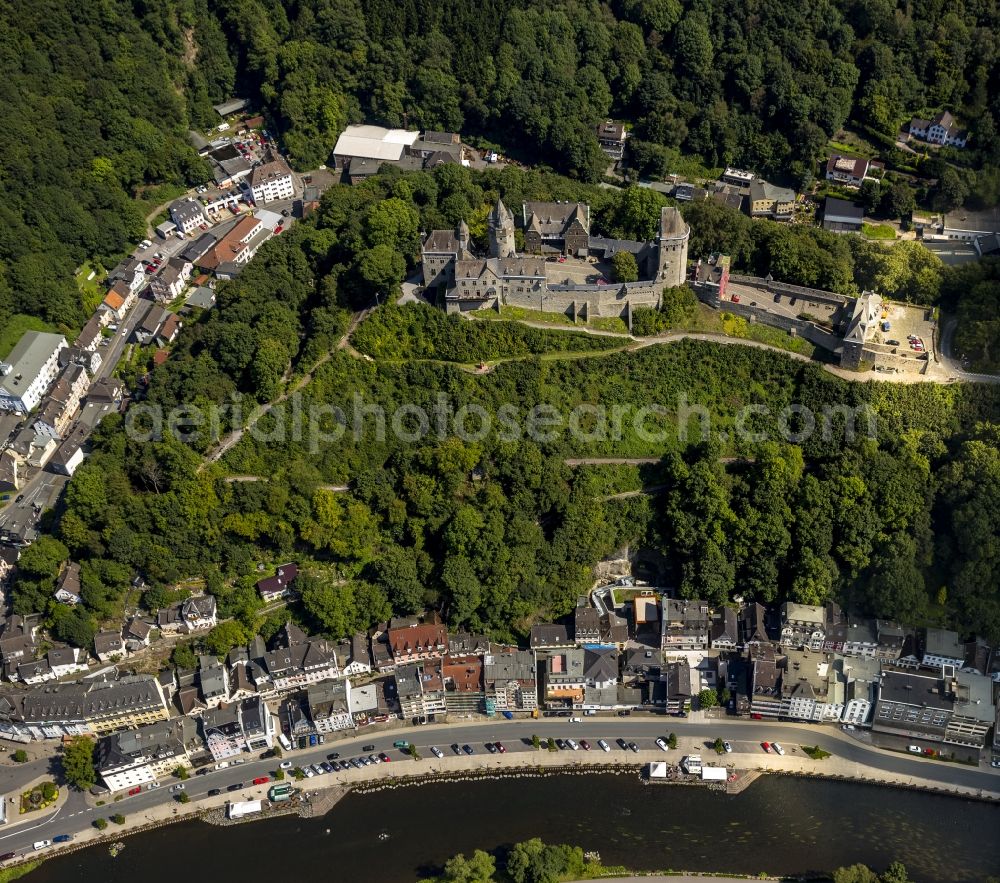 Altena from above - Altena castle on a tree-covered mountainside in Altena in the state North Rhine-Westphalia. It is located near the Lenneuferstrasse on the course of the Lenne. The castle houses several museums