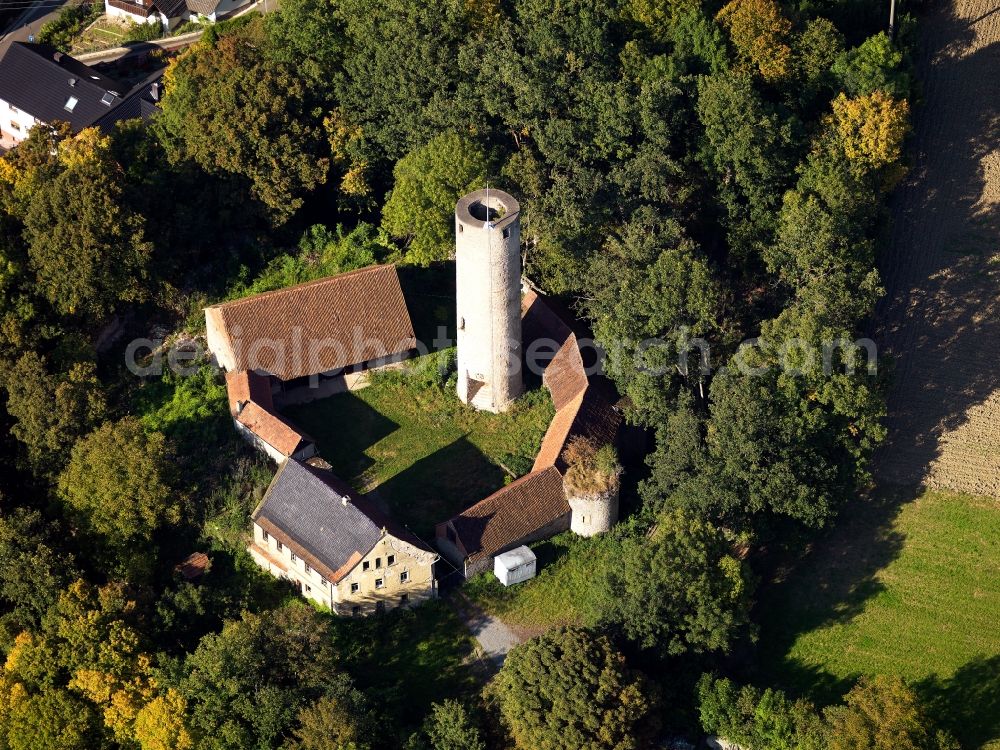 Arnstein from the bird's eye view: Fortress Büchold in the Büchold part of Arnstein in the state of Bavaria. The former high castle with the Roman castle keep, a ditch and cellar is located on a hill between forest and fields. Also called Castle Büchold, the ruins were renovated and the site is Wolfgang Gerberely owned now