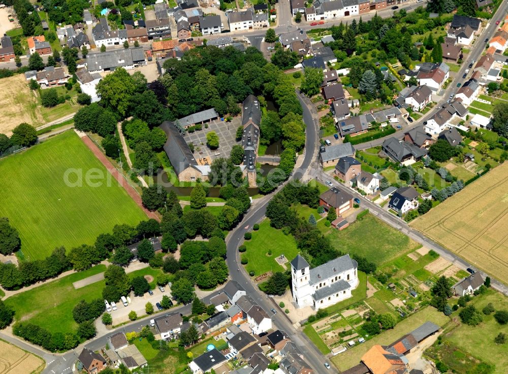 Birgel from above - Birgel Fortress in the Birgel part of the town of Düren in the state of North Rhine-Westphalia. The former water fortress with its distinct courtyard is surrounded by houses and residential homes and trees. It is located close to the church of St. Martinus. Today it is home to the public school Burg Birgel