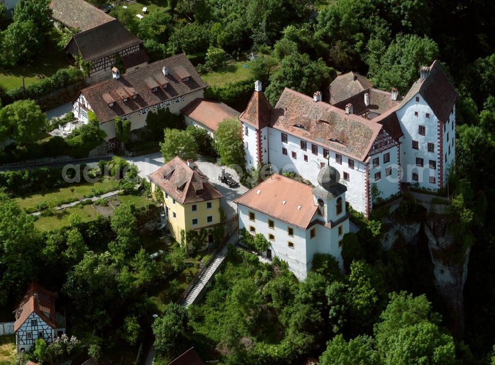 Aerial photograph Egloffstein - Egloffstein Castle in the town of Egloffstein in the state of Bavaria. The castle stems from the 12th century and consists of a main building and the upper castle. The parochial church St. Bartholomew was put in place in 1750 instead of the original castle chapel. The compound is sitting on a rock of the Rabenstein hill, 80m above the town in the Trubach valley