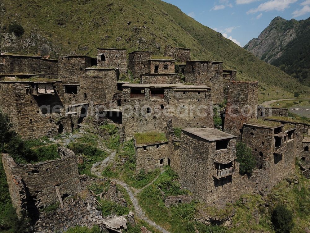 Aerial image Schatili - Castle of the fortress and fortified village in Schatili in Mtskheta-Mtianeti, Georgia