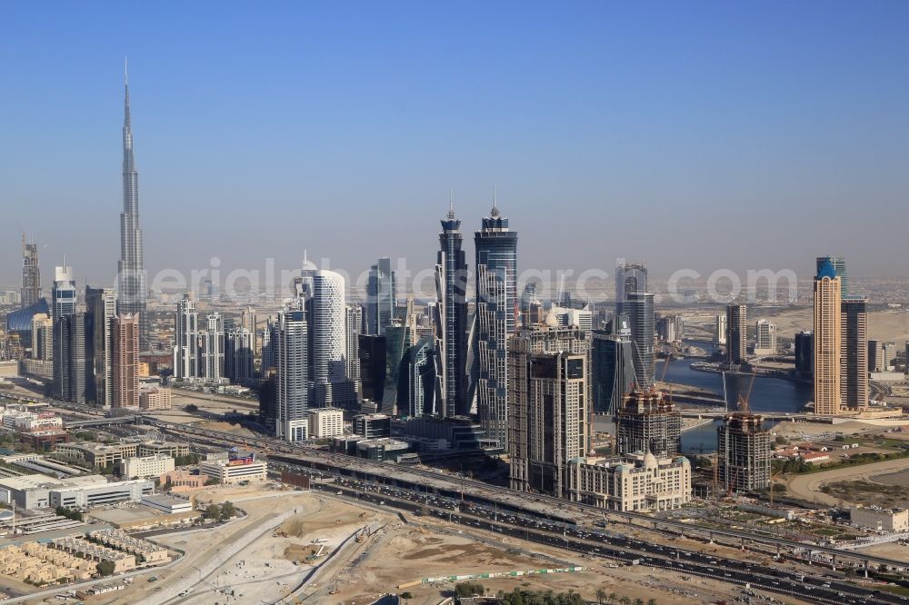 Aerial photograph Dubai - Burj Khalifa is uprising landmark and symbol for the explosively growing city of Dubai in the United Arab Emirates. Countless swanky skyscrapers are under construction and will change the cityscape and skyline to the EXPO 2020