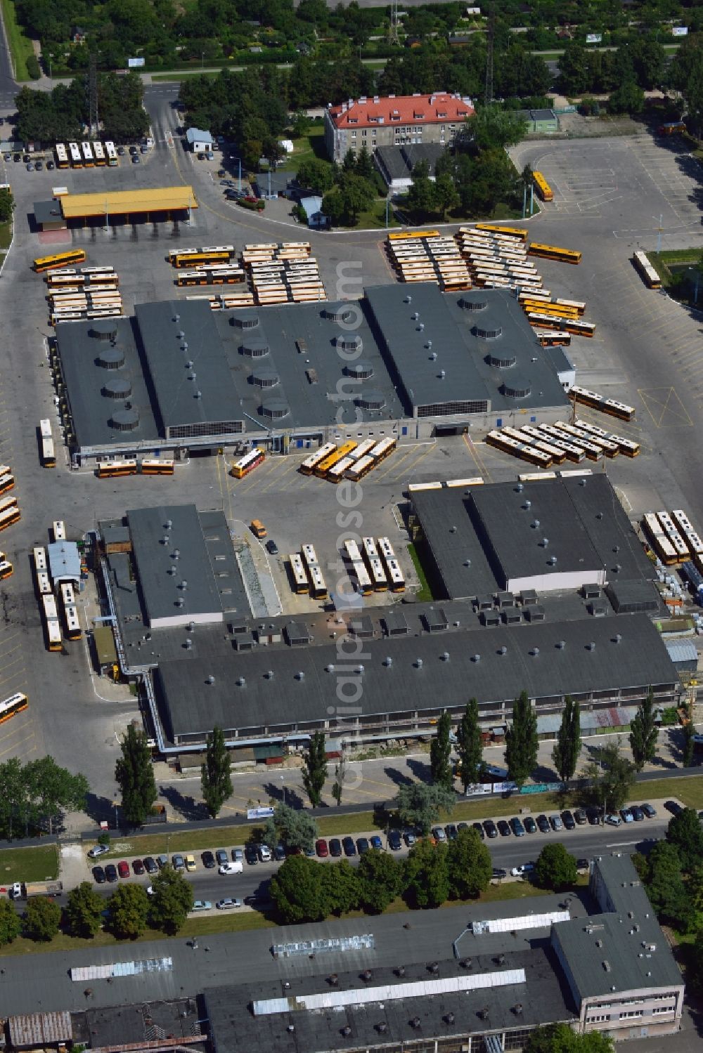 Warschau from above - Busses at the bus garage in the Mokotow District in Warsaw in Poland. The garage with its workshops, halls and parking lots is located on Jana Pawla Woronicza street. Several busses of the public transportation are parked here