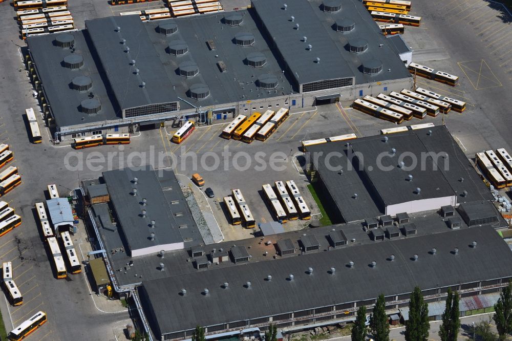 Warschau from the bird's eye view: Busses at the bus garage in the Mokotow District in Warsaw in Poland. The garage with its workshops, halls and parking lots is located on Jana Pawla Woronicza street. Several busses of the public transportation are parked here