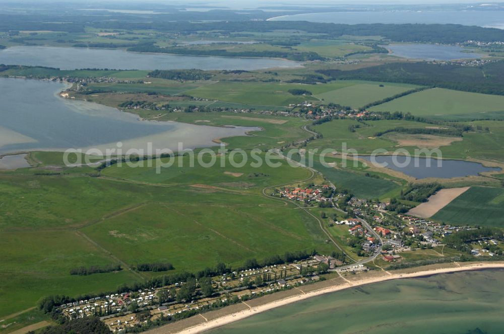 Lobbe from the bird's eye view: Blick über den Campinplatz Freizeit-Oase in Lobbe an der Ostsee auf Felder im Biosphärenreservat Südost Rügen und den Rügischen Bodden - Mecklenburg-Vorpommern MV. View over the campsite / campground Freizeit-Oase in Lobbe on the Baltic Sea onto fields of the biospheres reserve / preserve southeast Ruegen und the Rügischer Bodden - Mecklenburg-Western Pomerania.