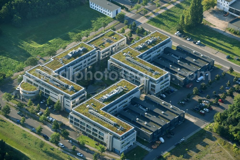 Berlin from above - View of clouds surrounding the campus of commercial area Wuhlheide Innovation Park in Berlin - Koepenick. The industrial area at Verlaengerte Kopenicker Strasse is location of many predominantly technology-oriented companies from various business branches. Operator is the Innovationspark Wuhlheide Managementgesellschaft mbH