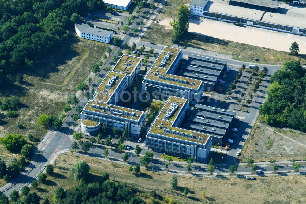 Aerial photograph Berlin - View of clouds surrounding the campus of commercial area Wuhlheide Innovation Park in Berlin - Koepenick. The industrial area at Verlaengerte Kopenicker Strasse is location of many predominantly technology-oriented companies from various business branches. Operator is the Innovationspark Wuhlheide Managementgesellschaft mbH