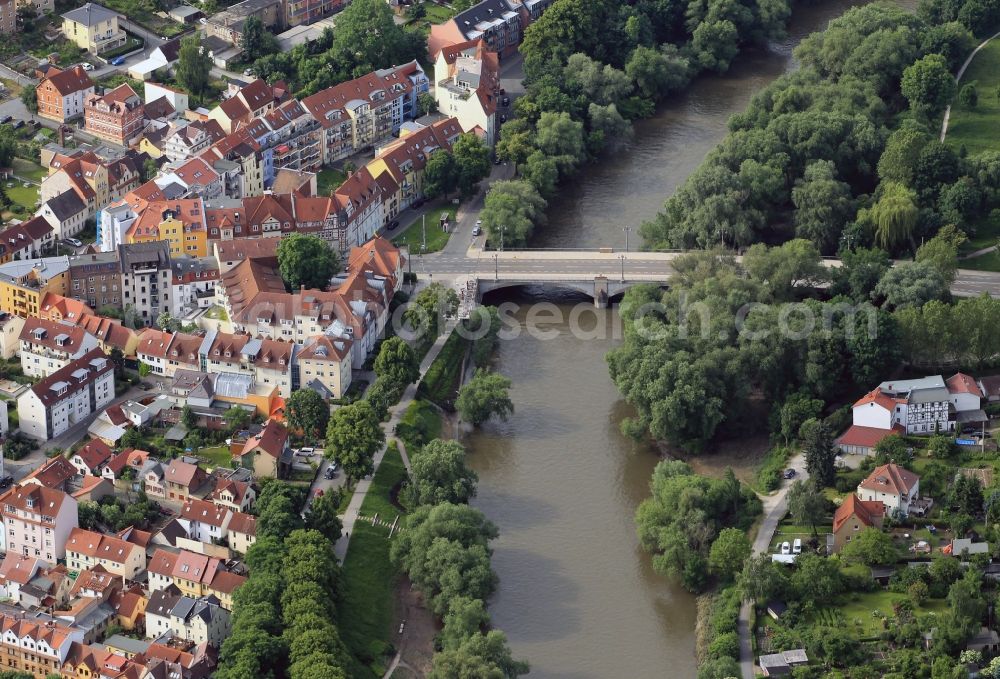 Jena from above - The Camsdorfer bridge over the Saale is the oldest stone bridge in Jena in Thuringia. Built in the Middle Ages, it is considered one of the seven wonders of Jena. It connects the city center with the district Wenigenjena. Right on the bridge is the traditional inn Gruene Tanne