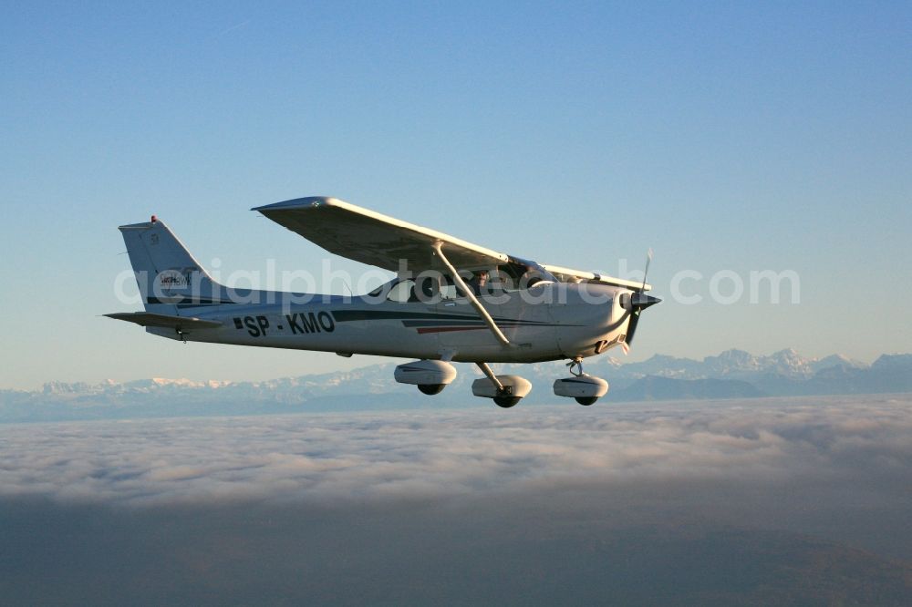 Aerial image Rheinfelden (Baden) - Light aircraft Cessna 172 call sign SP-KMO over the landscape of the Upper Rhine Region at Rheinfelden ( Baden ) in the state of Baden-Wuerttemberg. Blue sky and best panoramic view over the mountains of the Swiss Jura to the Swiss Alps