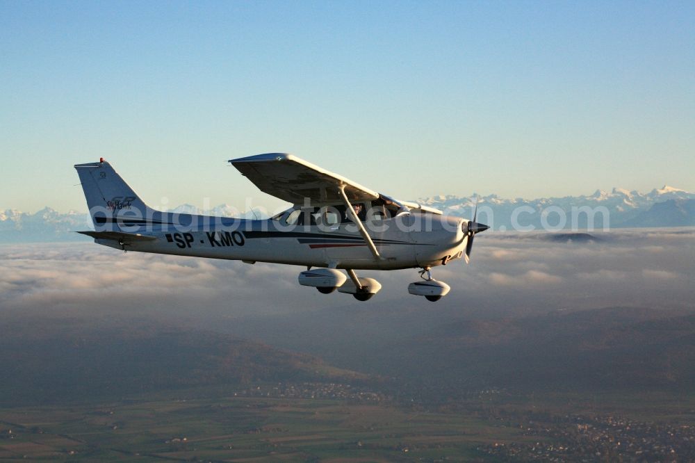 Aerial photograph Rheinfelden (Baden) - Light aircraft Cessna 172 call sign SP-KMO over the landscape of the Upper Rhine Region at Rheinfelden ( Baden ) in the state of Baden-Wuerttemberg. Blue sky and best panoramic view over the mountains of the Swiss Jura to the Swiss Alps