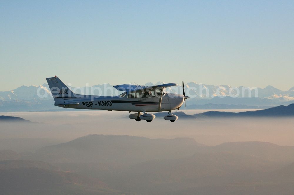 Rheinfelden (Baden) from the bird's eye view: Light aircraft Cessna 172 call sign SP-KMO over the landscape of the Upper Rhine Region at Rheinfelden ( Baden ) in the state of Baden-Wuerttemberg. Blue sky and best panoramic view over the mountains of the Swiss Jura to the Swiss Alps