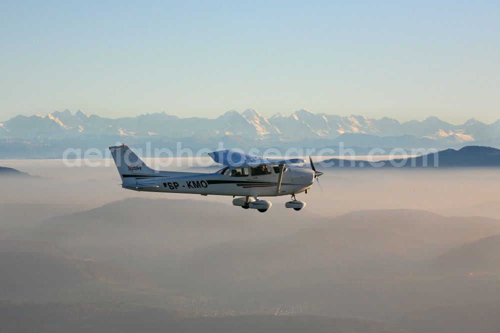 Aerial image Rheinfelden (Baden) - Light aircraft Cessna 172 call sign SP-KMO over the landscape of the Upper Rhine Region at Rheinfelden ( Baden ) in the state of Baden-Wuerttemberg. Blue sky and best panoramic view over the mountains of the Swiss Jura to the Swiss Alps