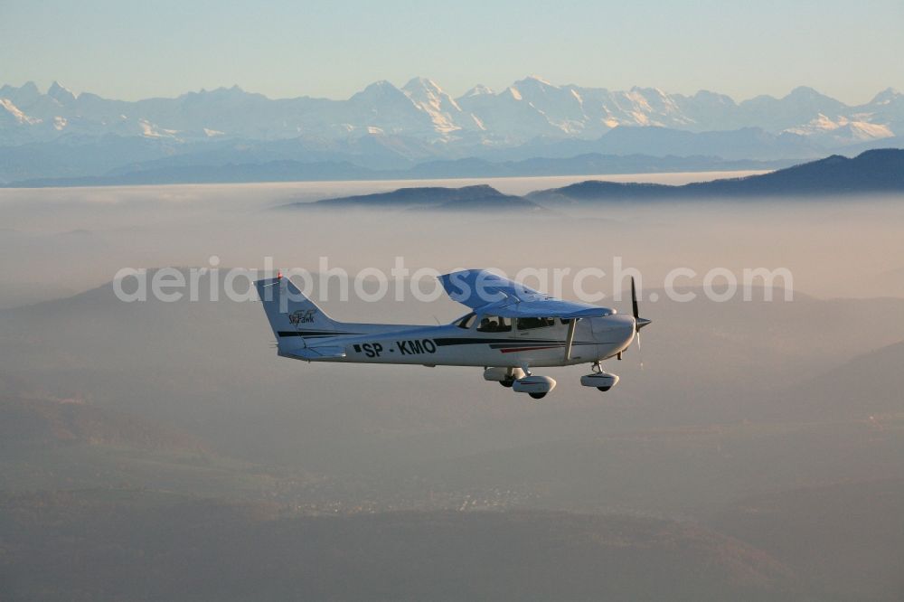 Aerial photograph Rheinfelden (Baden) - Light aircraft Cessna 172 call sign SP-KMO over the landscape of the Upper Rhine Region at Rheinfelden ( Baden ) in the state of Baden-Wuerttemberg. Blue sky and best panoramic view over the mountains of the Swiss Jura to the Swiss Alps