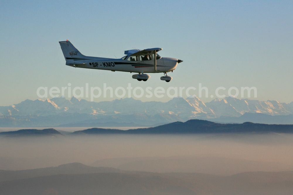 Aerial image Rheinfelden (Baden) - Light aircraft Cessna 172 call sign SP-KMO over the landscape of the Upper Rhine Region at Rheinfelden ( Baden ) in the state of Baden-Wuerttemberg. Blue sky and best panoramic view over the mountains of the Swiss Jura to the Swiss Alps