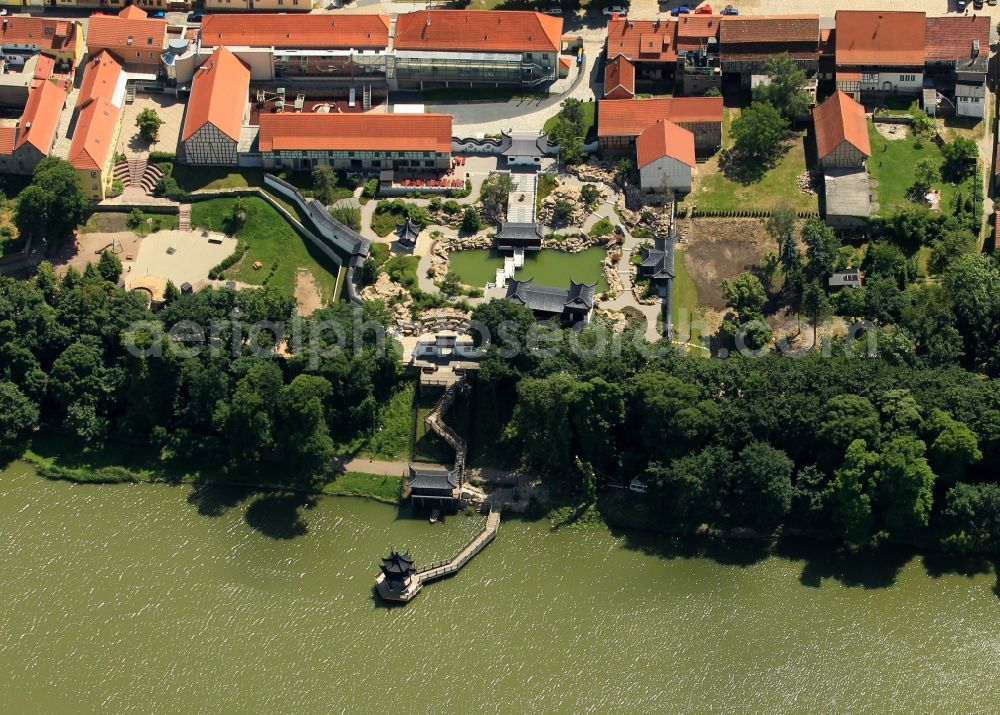 Weißensee from the bird's eye view: At the Gondelteich Weissensee in Thuringia emerged in recent years, a Chinese garden. The Chinese Garden connects directly to the old town and was designed as part of the State Garden Show. Several buildings on the Chinese model as the gateway to the foresight of the Pavillion of scented water and lake-pavilion form the structural framework for the garden landscape. Typical plants and garden elements round off the picture