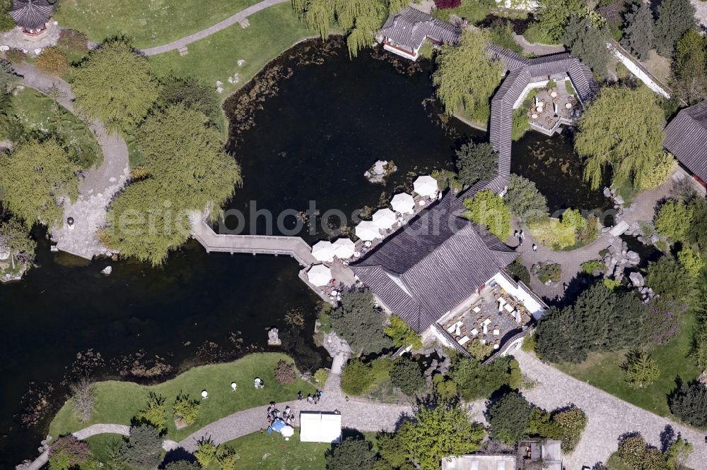 Berlin from the bird's eye view: Chinese Tea House and pond in the Chinese Garden part of the premises of the IGA 2017 in the district of Marzahn-Hellersdorf in Berlin, Germany. The main attraction of the international garden show will be the Gaerten der Welt which include the Chinese Garden and small lake