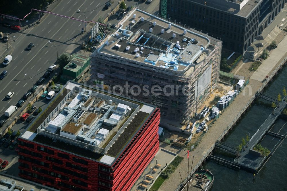 Aerial image Berlin - Coca-Cola- House on Stralauer Allee and the riverbank of the Spree in the Friedrichshain part of Berlin in Germany. The red building is part of a series of new buildings on the river